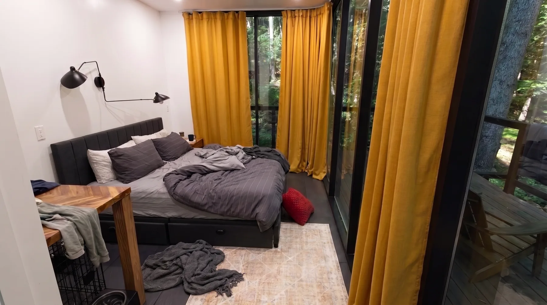 Before cleaning: a bedroom with rumpled bedding and a throw on the floor