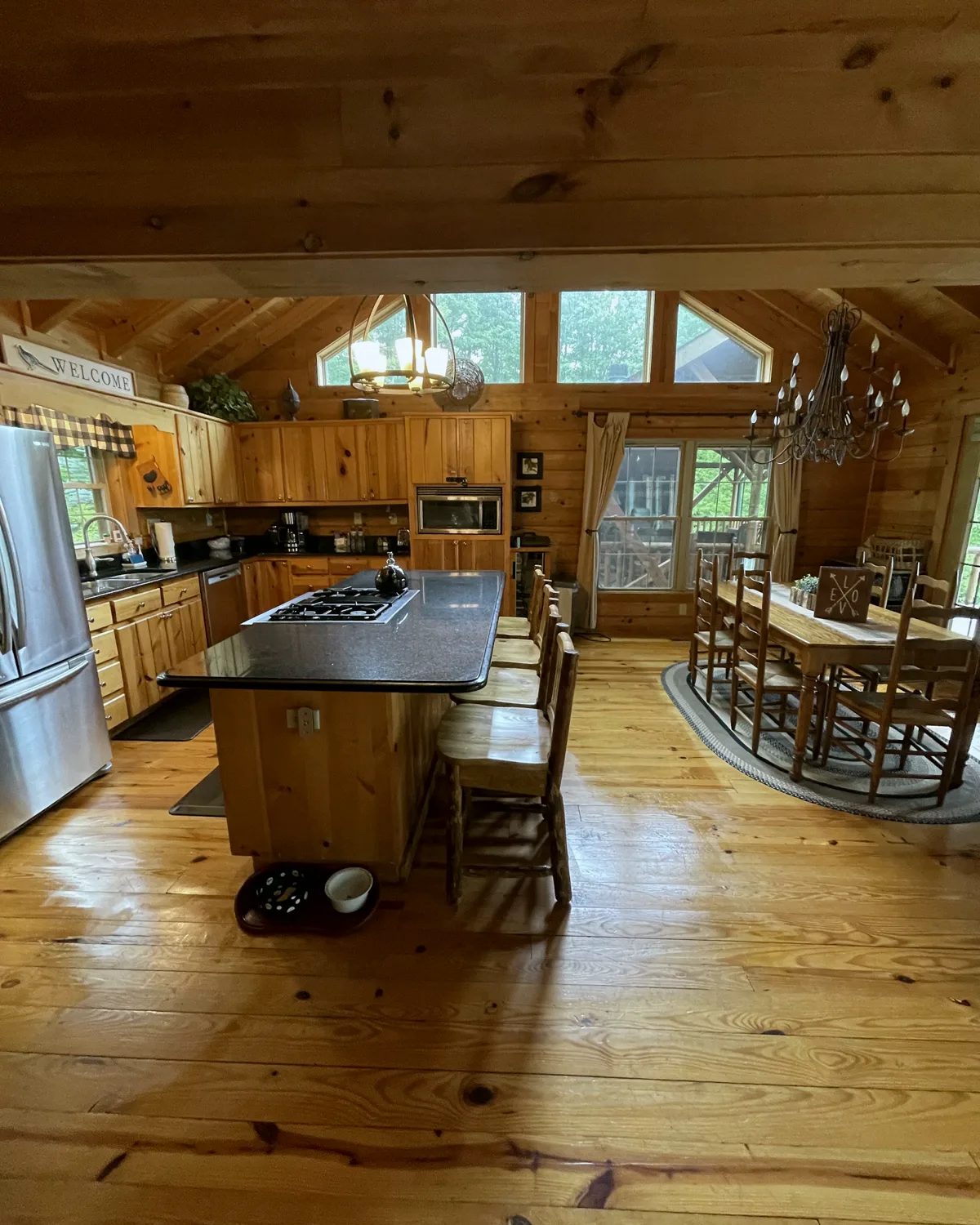 A clean mountain cabin kitchen with an island and warm wood cabinetry
